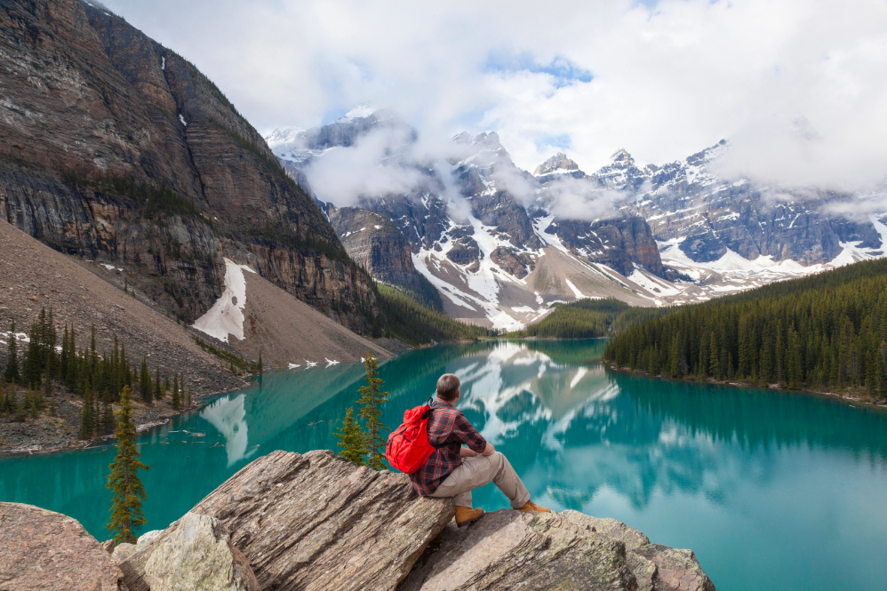Hiking Man Looking at Moraine Lake & Rocky Mountains